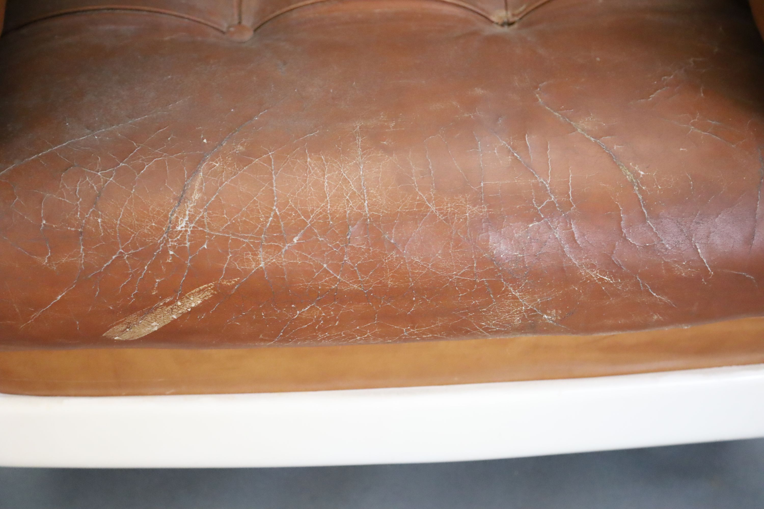 A pair of mid century tan leather and fibreglass tub chairs, possibly French, by Airbourne, W.3ft 1in. D.2ft 7in. H.2ft 8in.